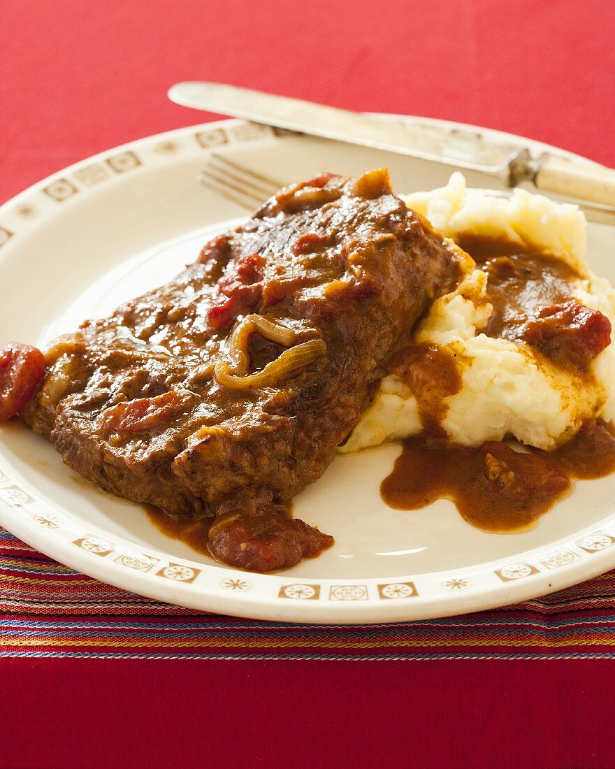 Swiss Steak with Mashed Potatoes; Tomato Sauce Covered Steak