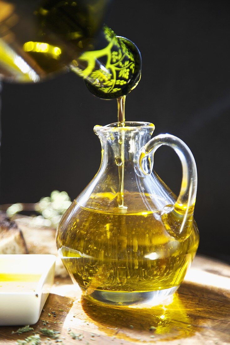 Cold Press, Organic Virgin Oil Pouring into a Small Pitcher