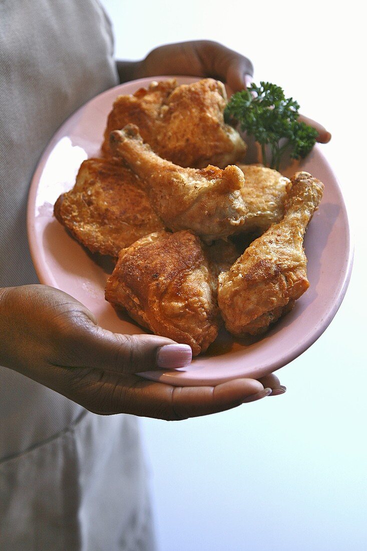Woman Holding a Plate of Organic Fried Chicken