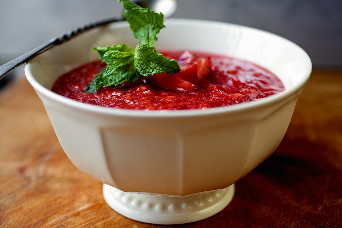 Bowl of Strawberry Sauce with Mint Sprig
