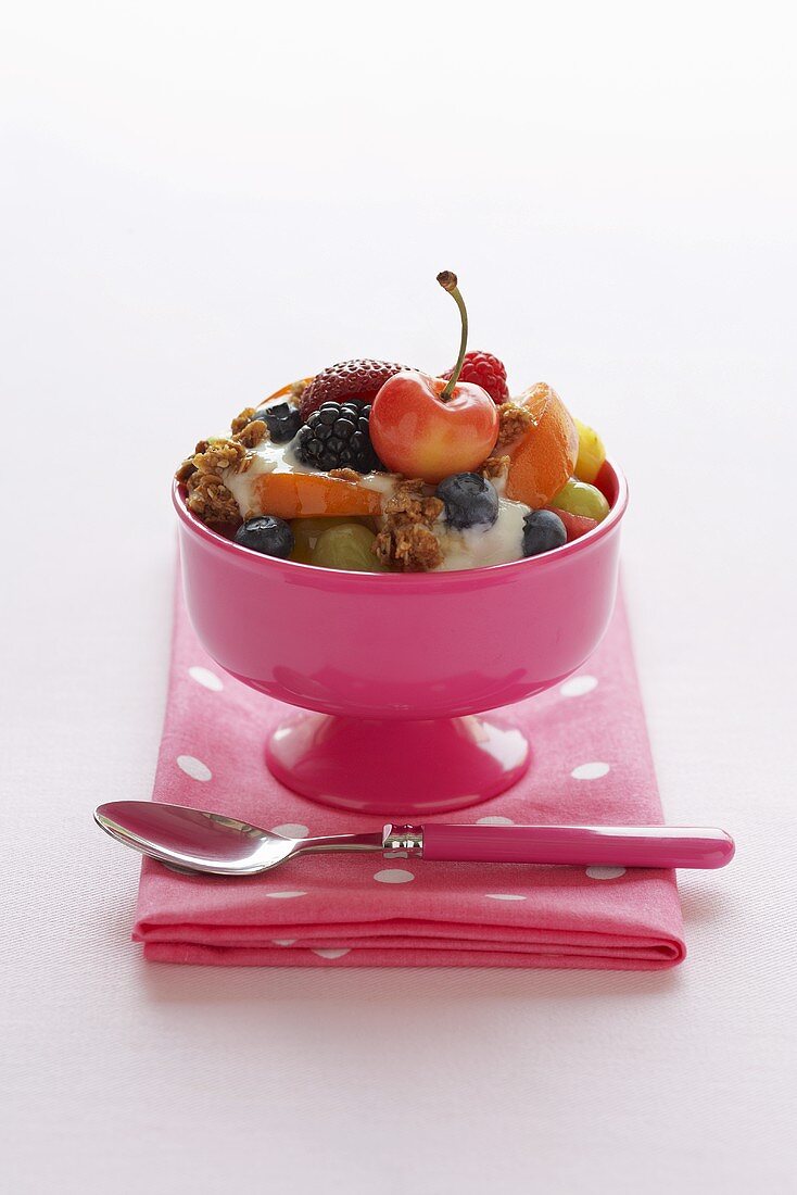 Bowl of Fruit Salad with Yogurt and Granola with Cherry on Top