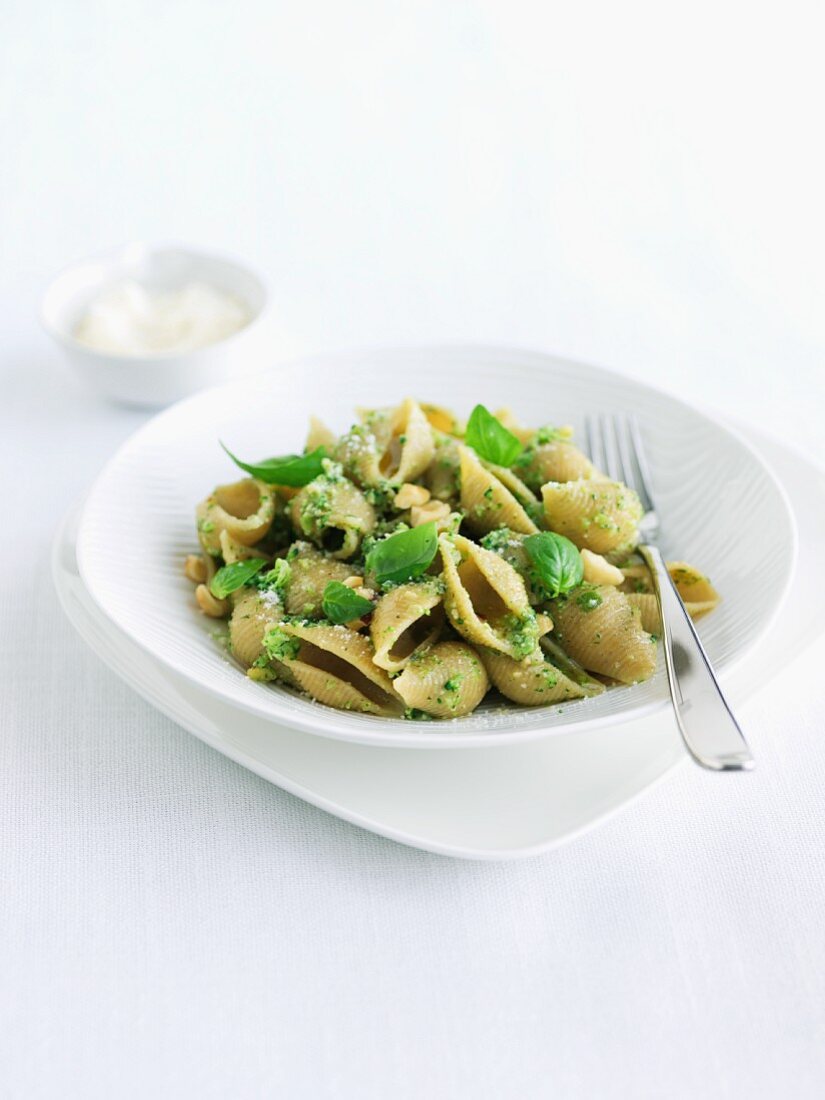 Bowl of Whole Wheat Pasta with Broccoli Pesto and Basil Garnish