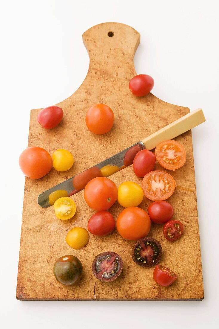 Baby Heirloom Tomatoes; Whole and Halved on Cutting Board