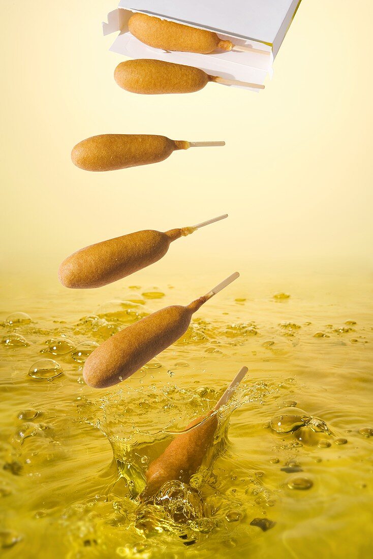 Corndogs Falling into Oil to Deep Fry