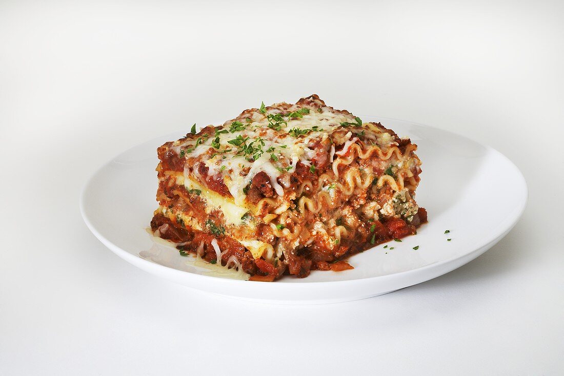 Piece of Lasagna on a White Plate; White Background