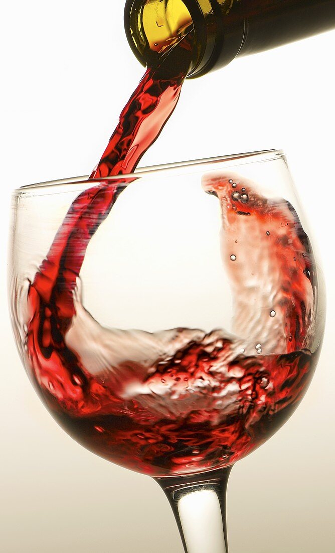 Rotwein in Glas einschenken