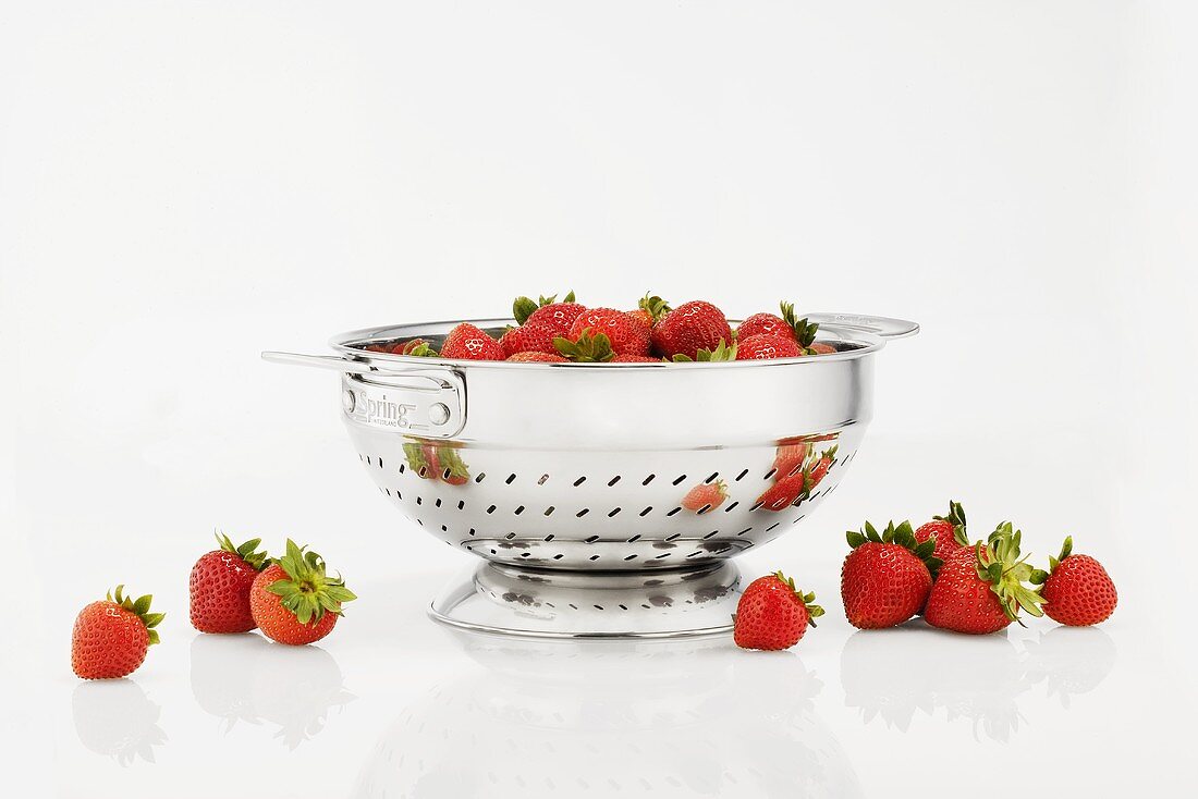 Fresh Strawberries in and Around a Colander