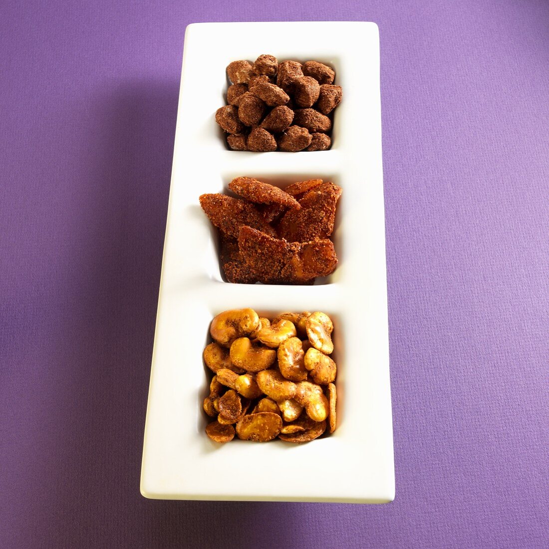 Divided Serving Dish with Habas Con Chile (Lima Beans with Chili), Rebanadas de Mango (Mango with Chili) and Saladitos con Chili (Salted Dried Plums with Chili)