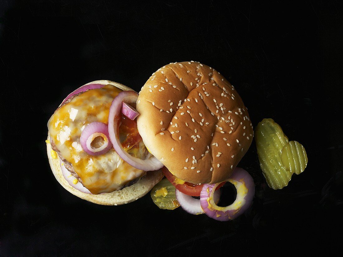 Cheeseburger with onions and gherkins