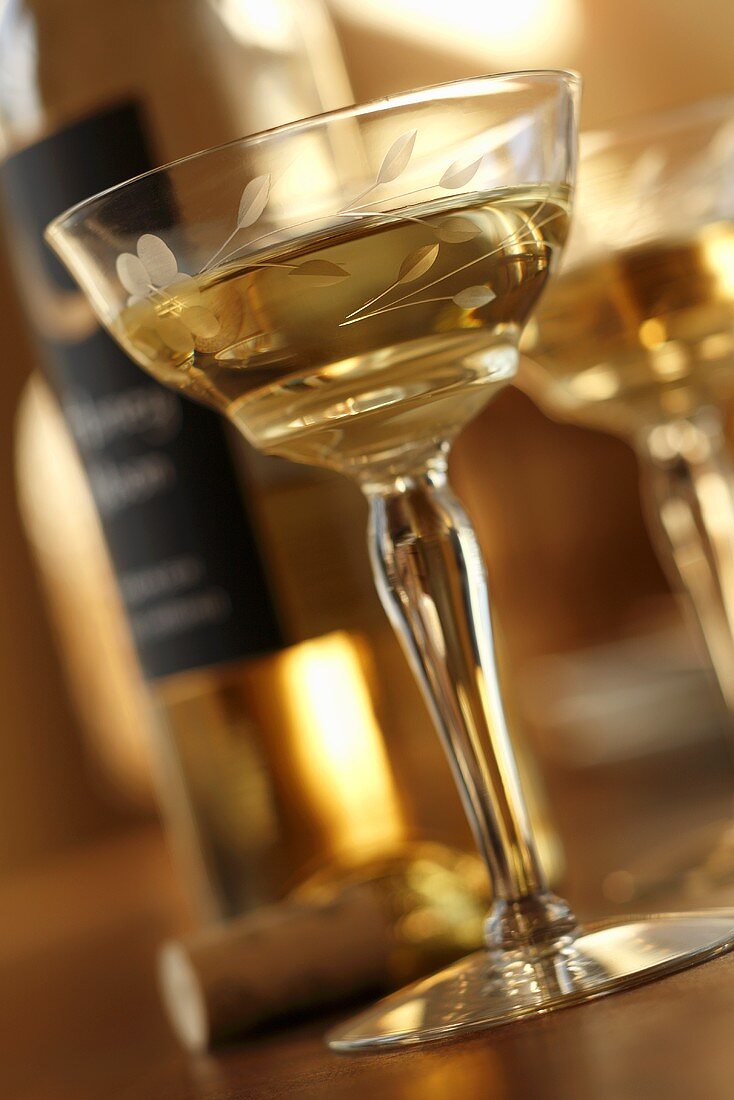 Glass of White Wine; Bottle and Cork in Background