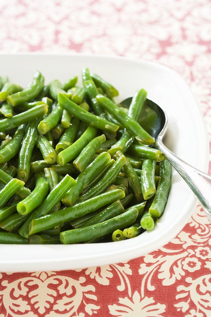 Cooked Green Beans in a Serving Bowl with Spoon
