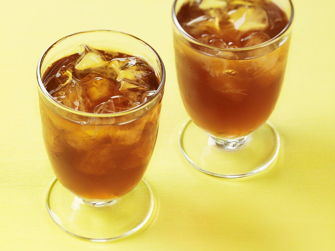 Two Glasses of Iced Tea on Yellow Surface