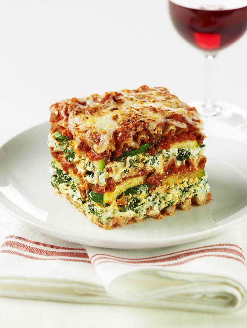 A slice of spinach and courgette lasagne on a plate