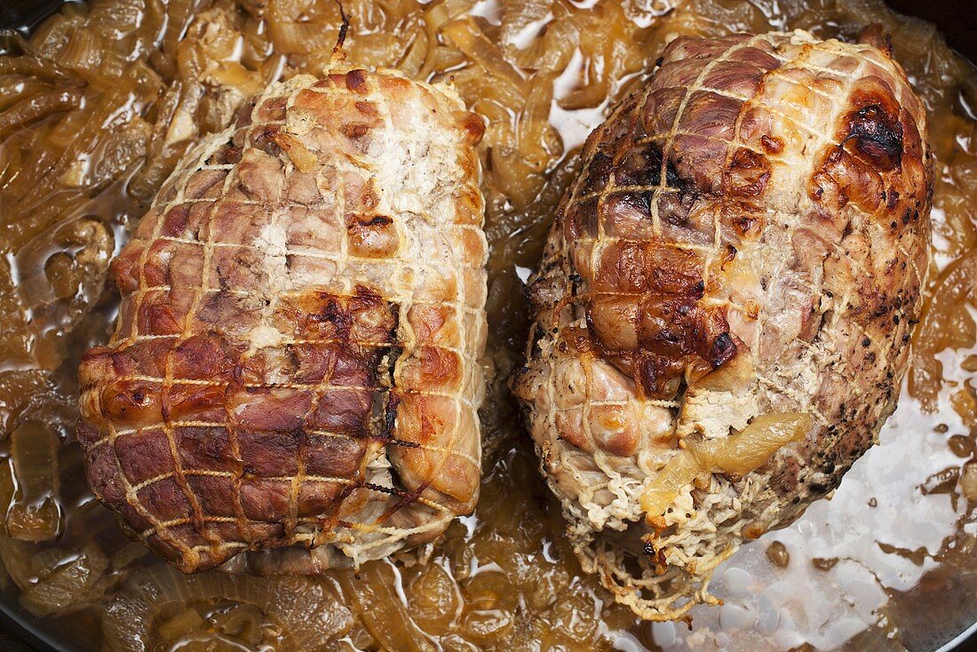 Two Roasted Pork Shoulders Cooked with Onions