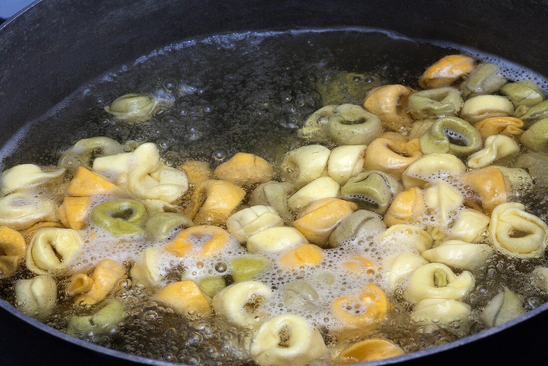 Tri-Colored Tortellini Cooking in a Pot of Boiling Water