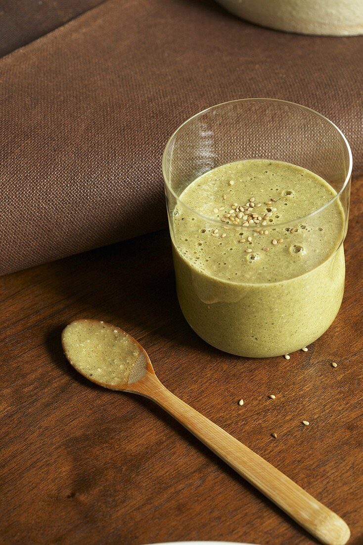 Healthy Green Juice with Sesame Seeds; Wooden Spoon