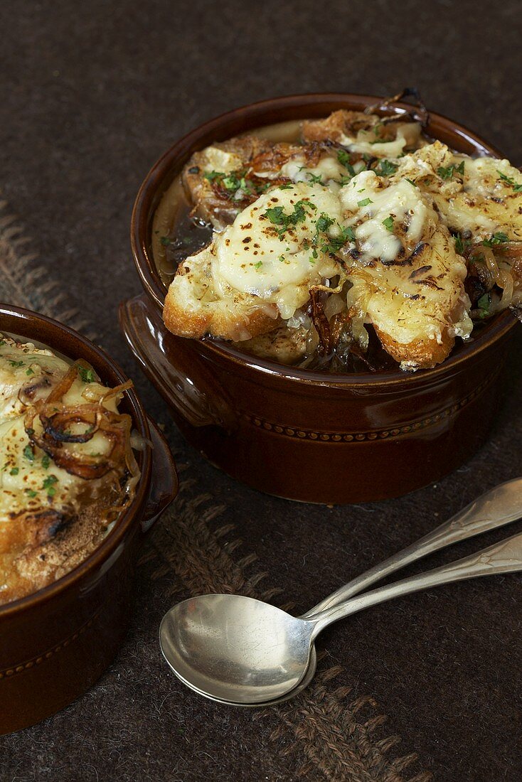 Two Bowls of French Onion Soup with Chopped Parsley