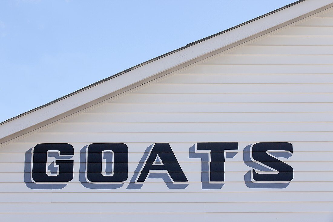 Building with the Word Goats Painted on; Barn at Fair