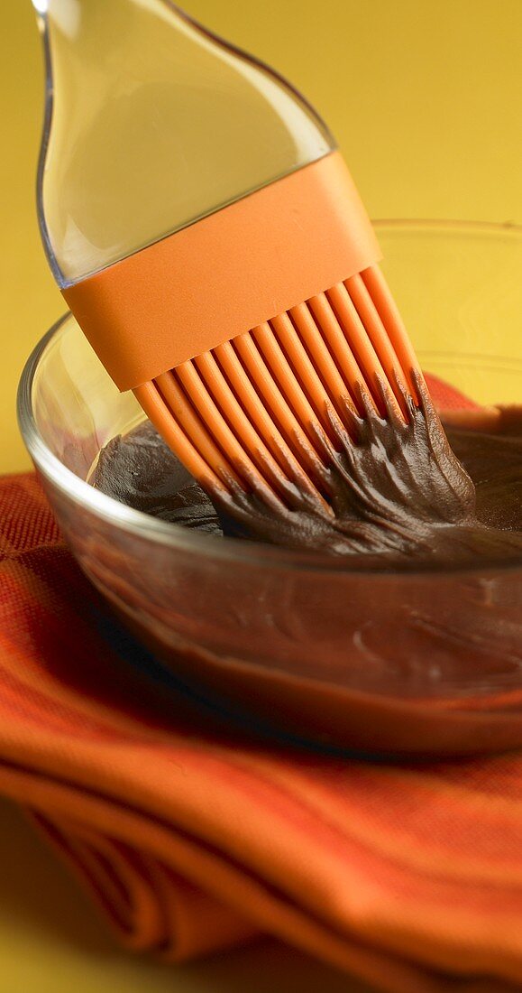 Silicone Brush in a Bowl of Chocolate Frosting
