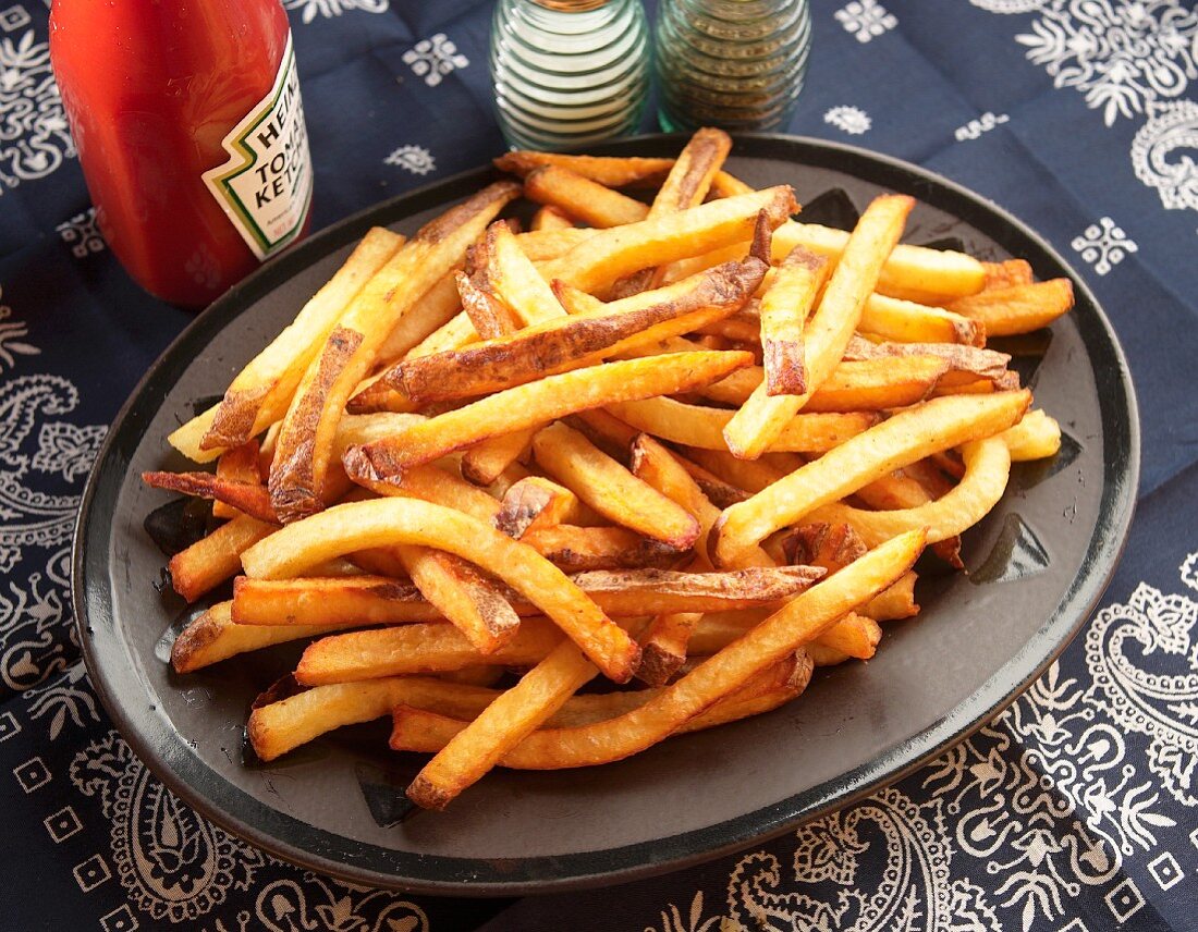 Large Plate of French Fries; Bottle of Ketchup