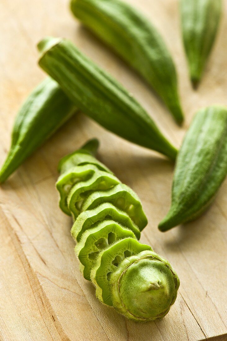 Sliced Okra with Whole Okra on a Cutting Board