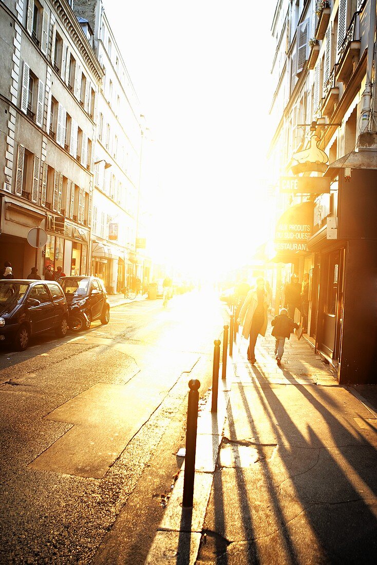 People Walking on a Street in Paris, France at Sunset