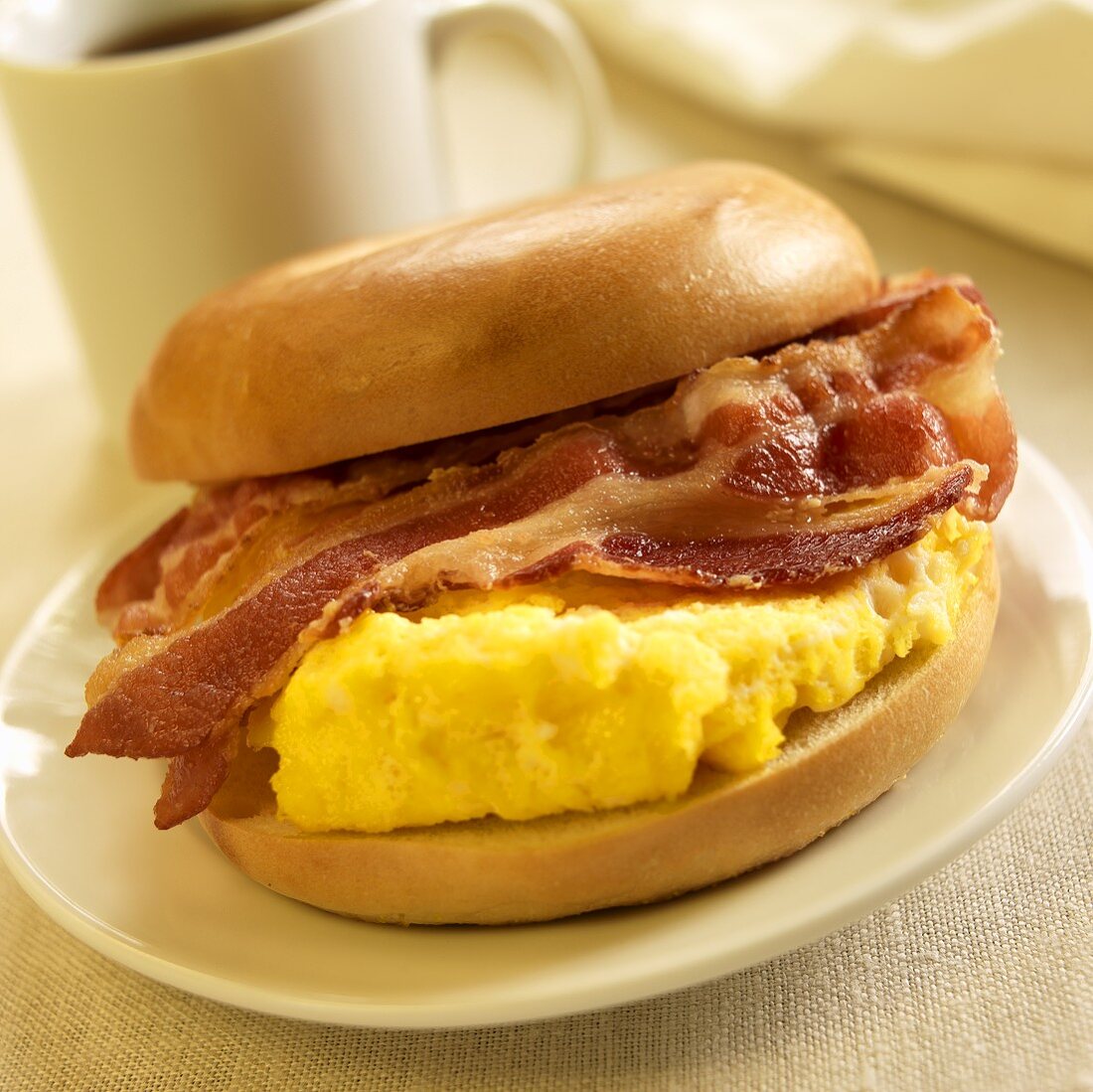 Breakfast Sandwich; Scrambled Egg and Bacon on a Bagel; Coffee
