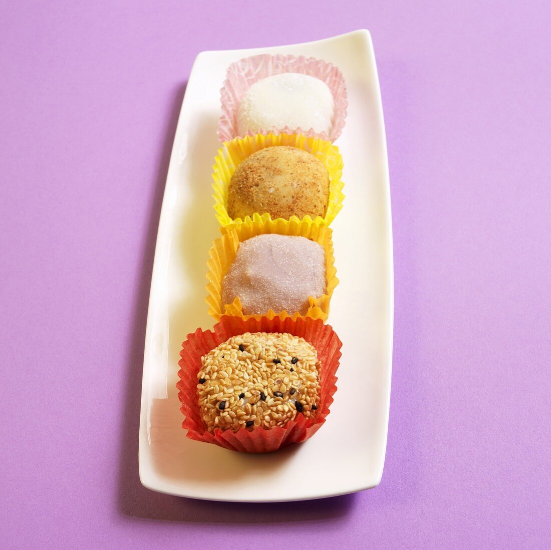 Japanese Mochi (sweets) on a White Platter; Purple Background