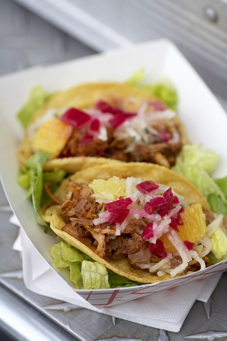 Pork tacos with beetroot and pineapple in a take away box