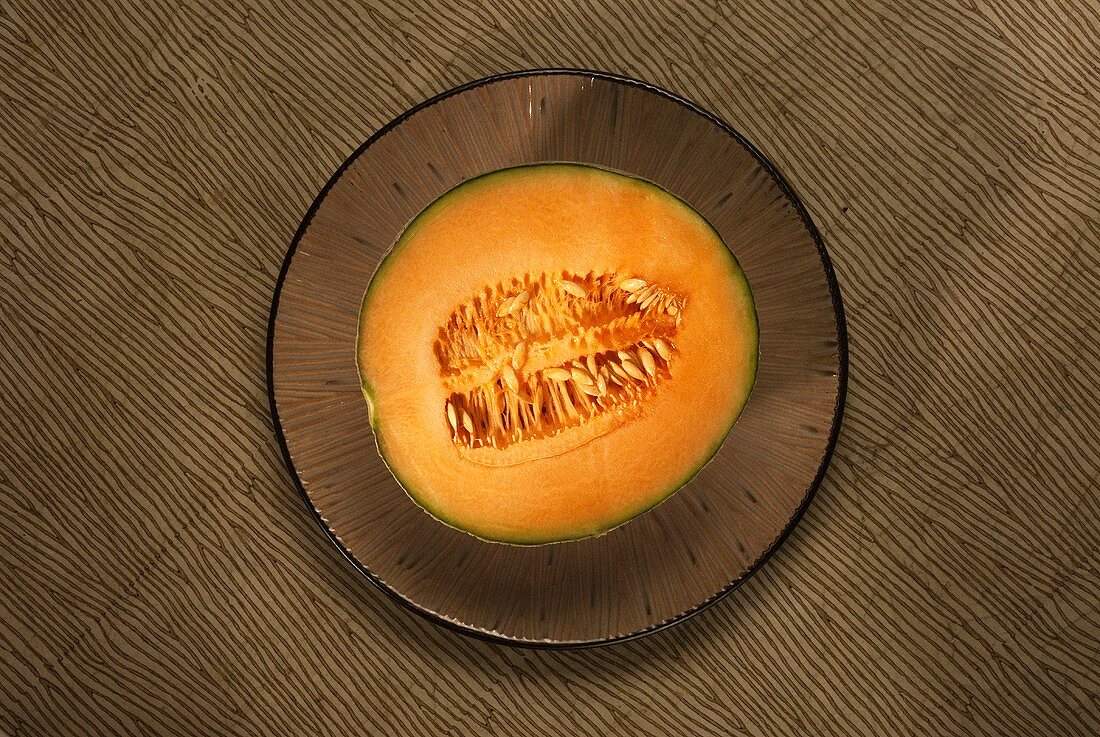 Half of a Cantaloupe on a Plate; From Above