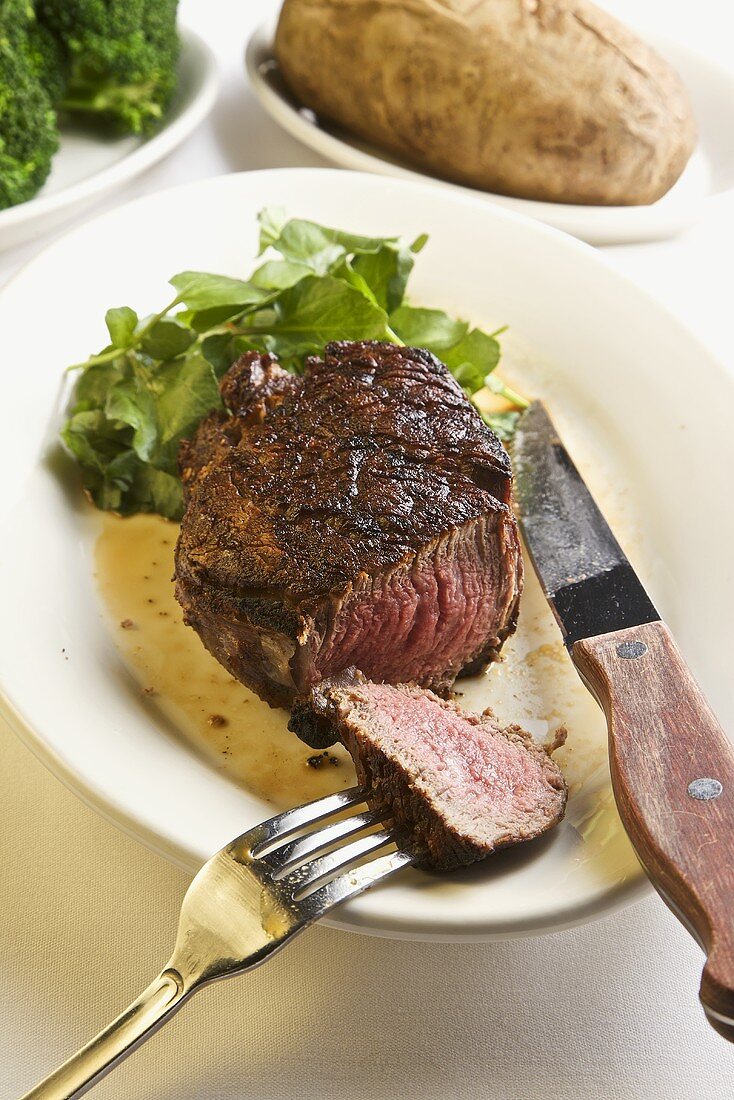 Filet Mignon; Sliced with Fork and Knife; Baked Potato and Green Salad
