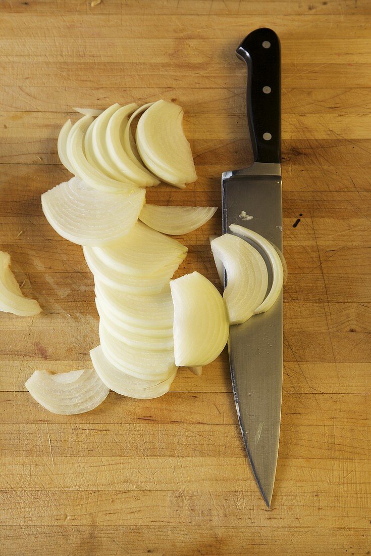 Sliced Onion on Butcher Block; Knife