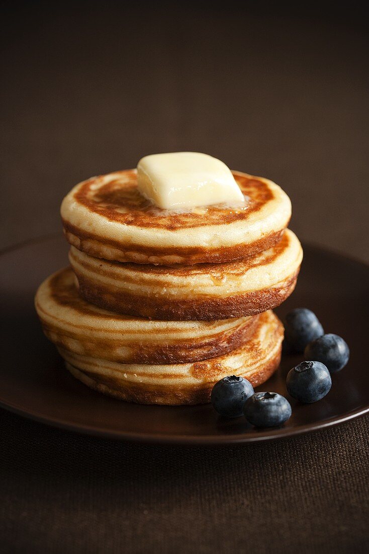 Stack of Four Pancakes with Butter and Blueberries