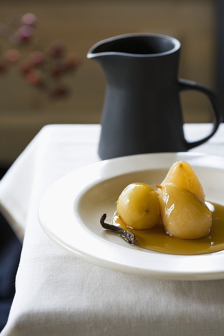Three Baked Pears with Maple Syrup in a White Bowl