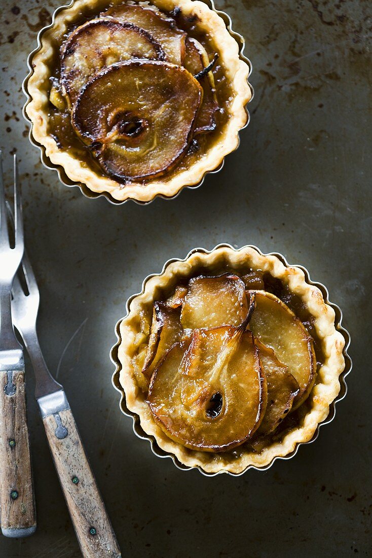 Two Mini Pear Tarts in Fluted Baking Tins; From Above