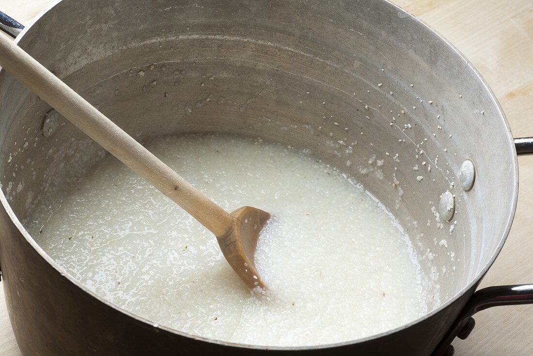 Large Pot of Grits with Wooden Spoon