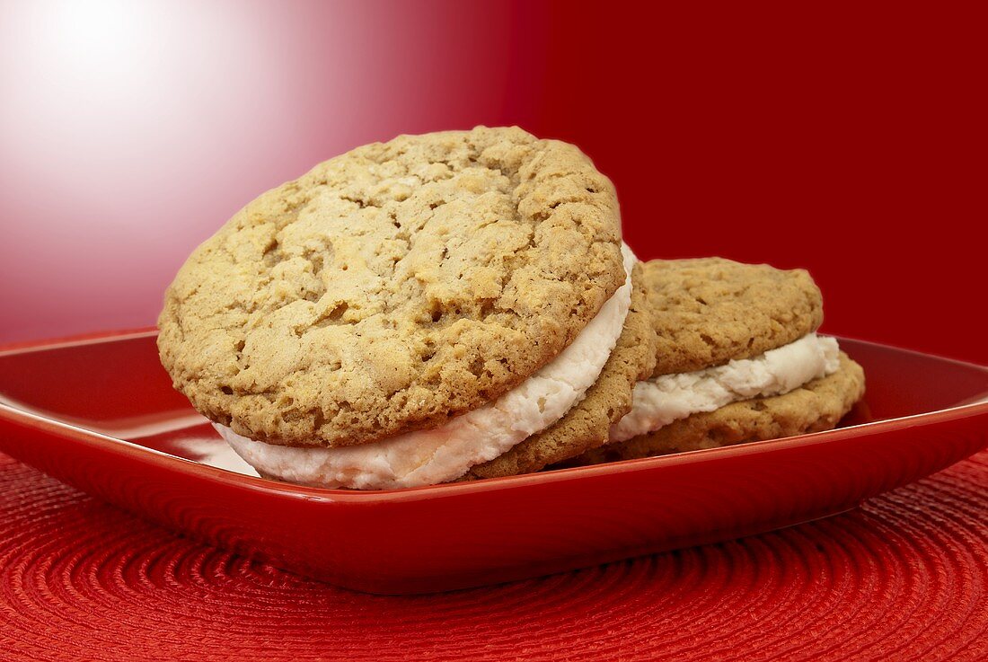Two Oatmeal Whoopie Pies on a Red Plate