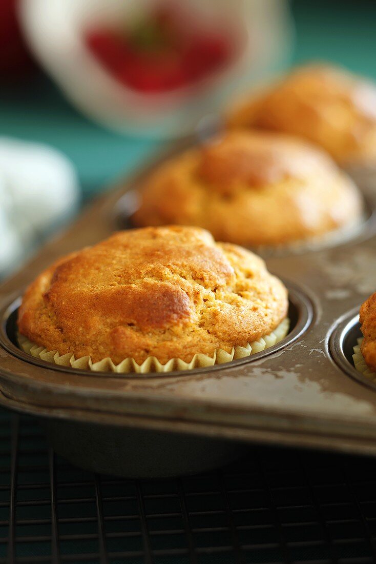 Freshly Baked Muffins Cooling in the Pan on a Rack