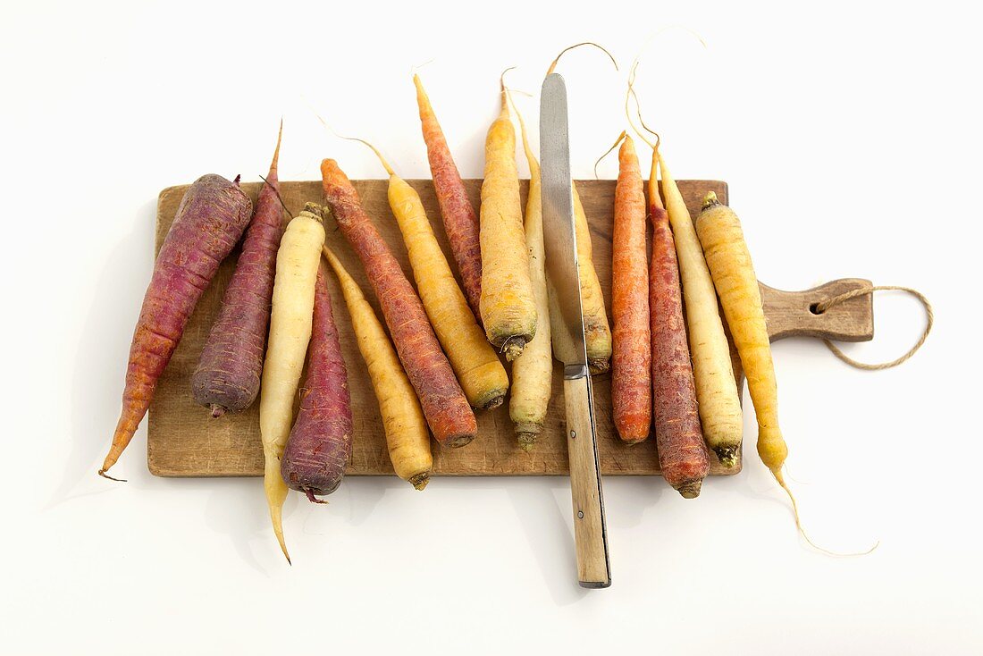 Heirloom Carrots on a Cutting Board with a Knife