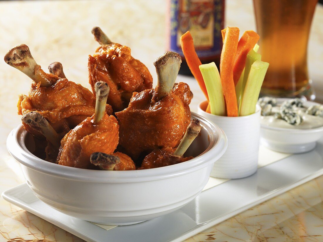 Buffalo chicken wings with carrot and celery sticks and blue cheese dip