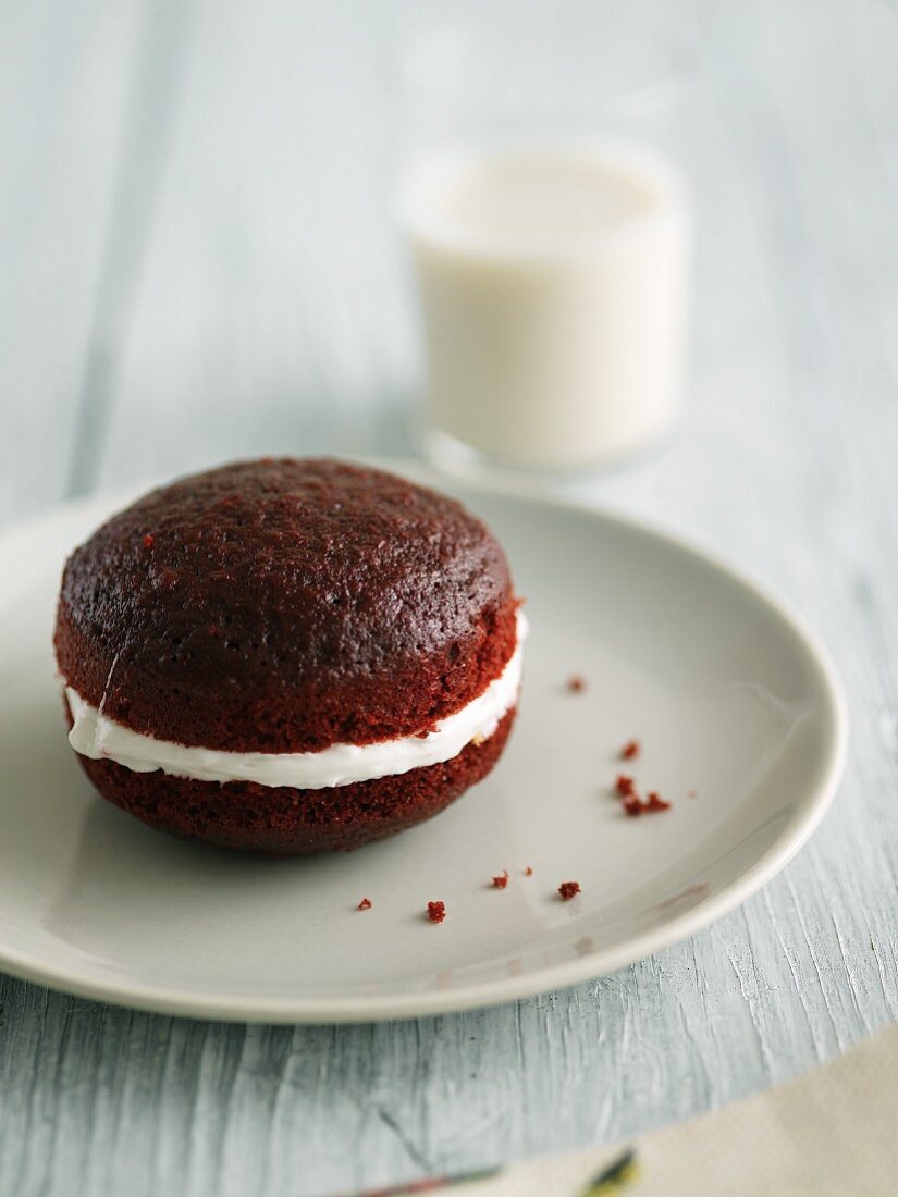 Red Velvet Whoopie Pie on a Plate; Glass of Milk