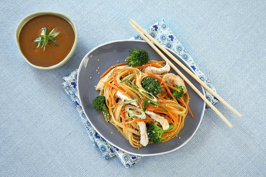 Sesame Chicken and Broccoli Over Asian Noodles; Chopsticks