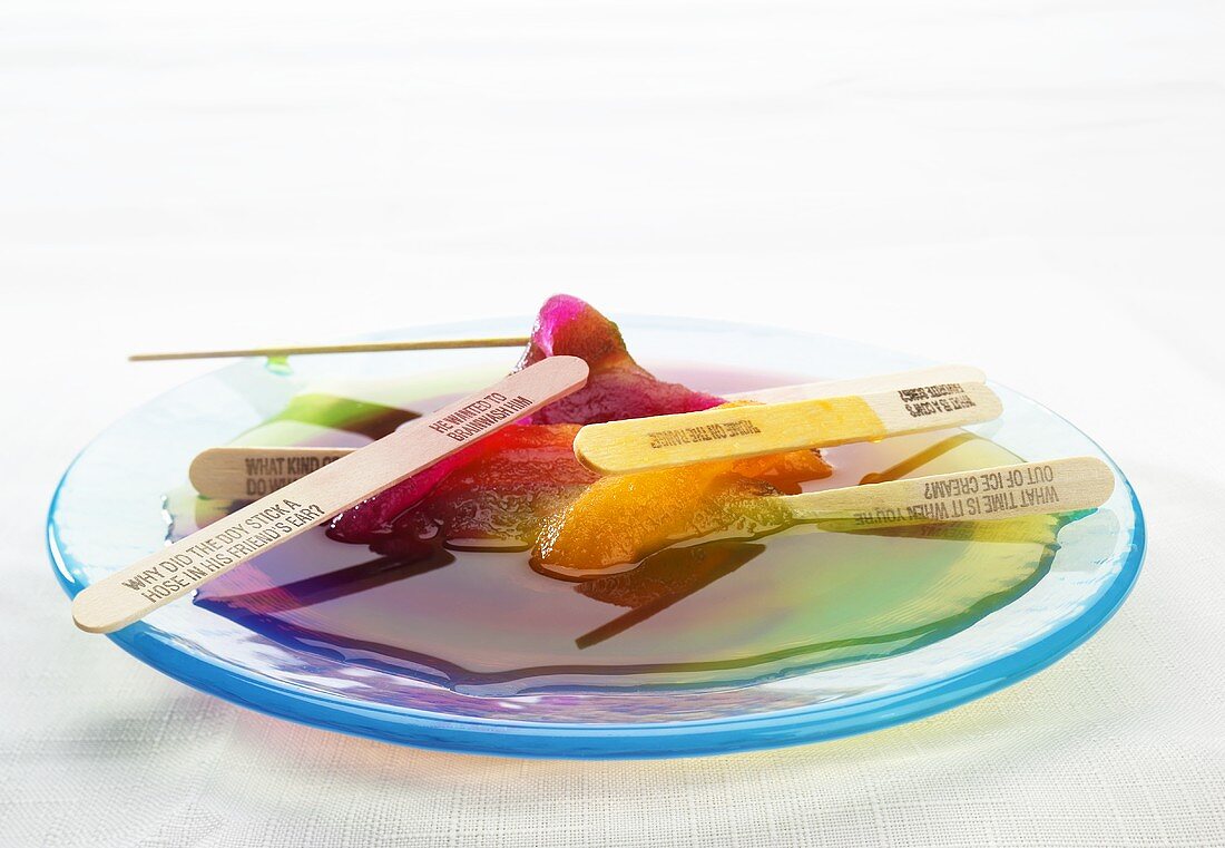 Multi-Colored Popsicles Melting on a Blue Plate