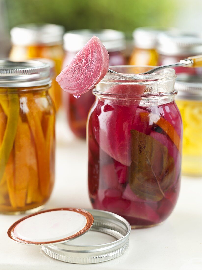 Open Jar of Pickled Beets with One on a Fork; Pickled Beans