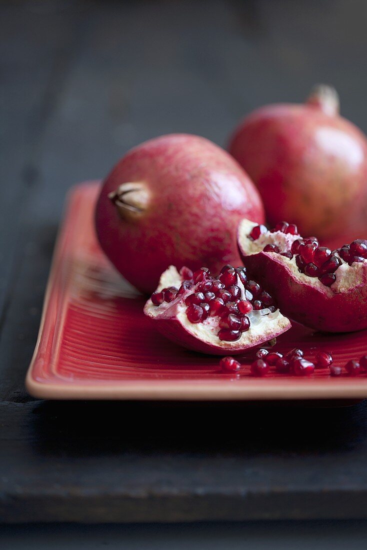 Pomegranates, whole and cut open