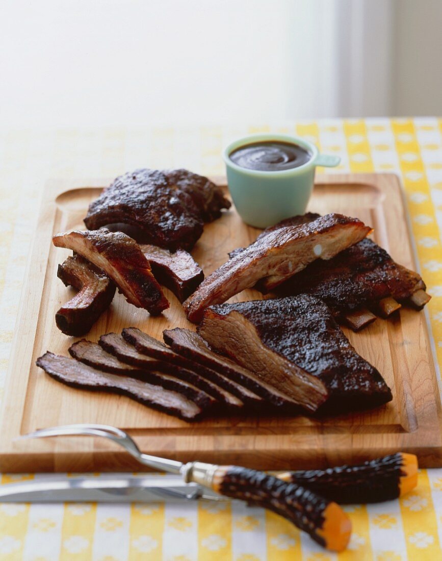 Grilled Barbecue Ribs and Brisket on a Cutting Board