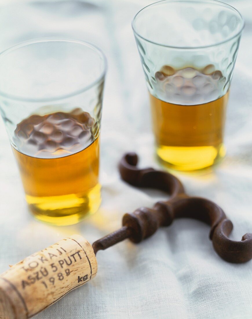 Two Glasses of White Wine with a Wine Cork on a Cork Screw