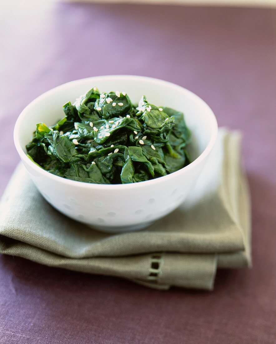 Bowl of Wilted Spinach with Sesame Oil and Sesame Seeds