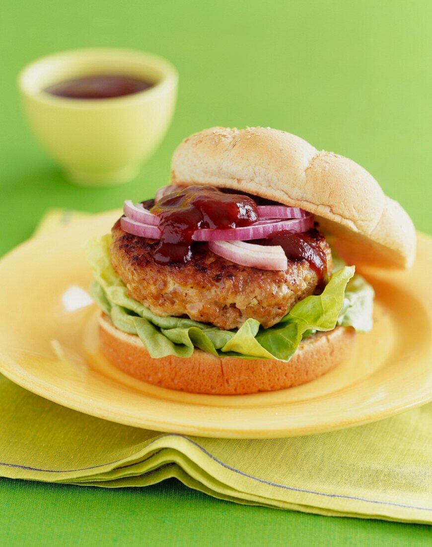 Pork Burger with Red Onion and Lettuce on a Roll