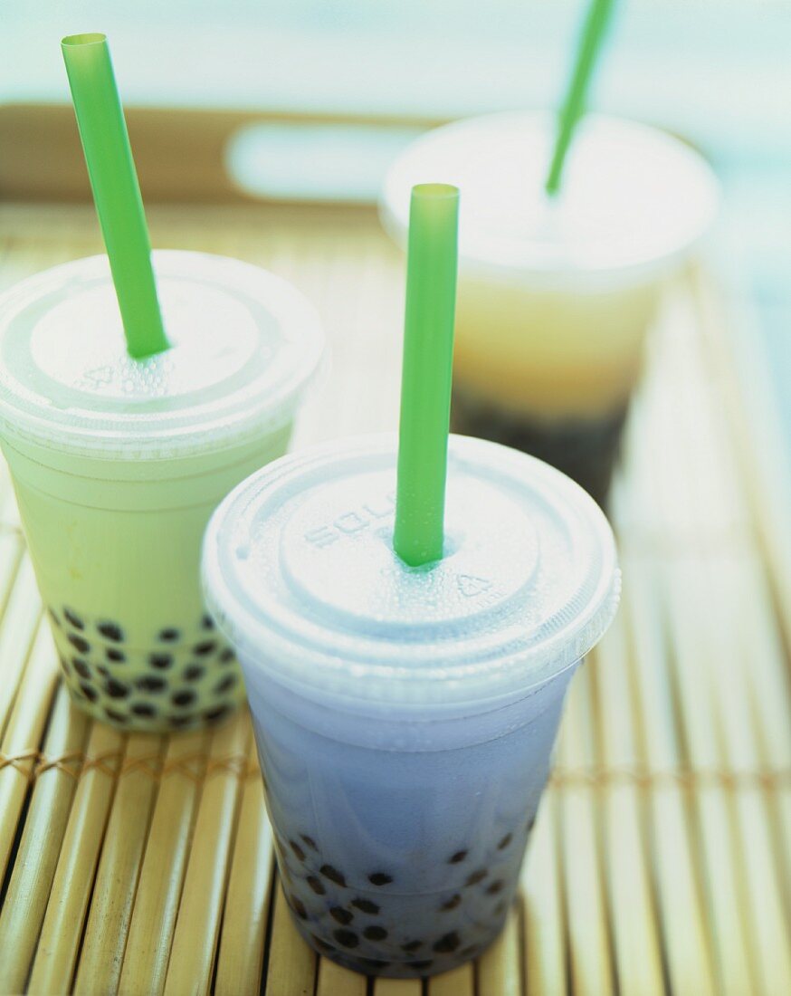 Three Assorted Tapioca Drinks in Plastic Take Out Cups with Straws